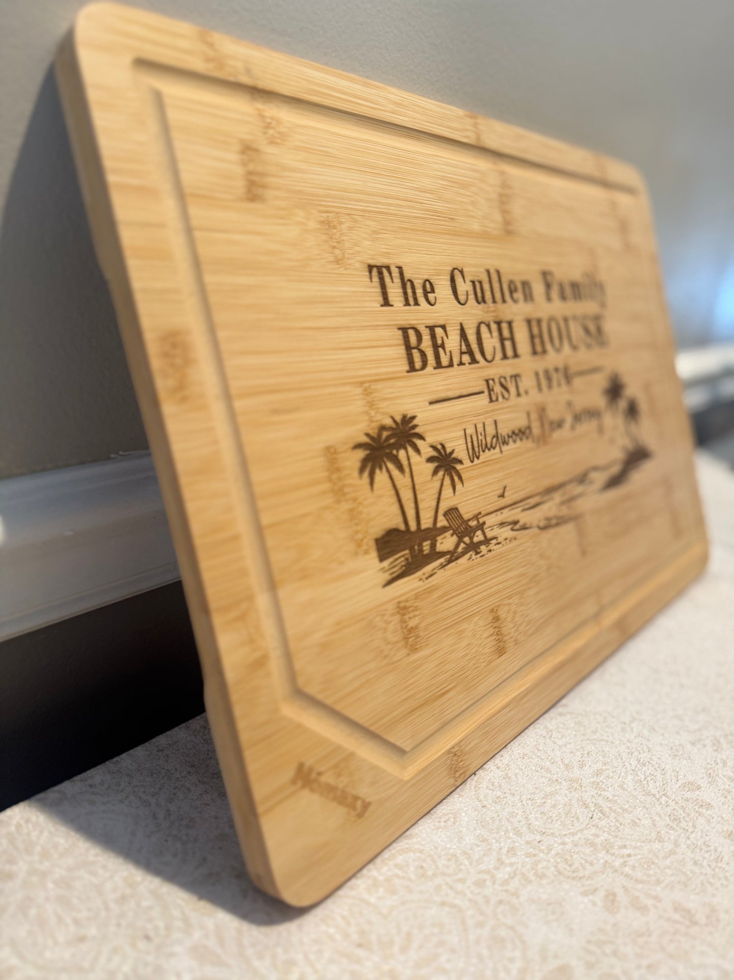 Wooden cutting board with engraved text and design on a white surface