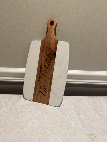 Wooden and white cutting board with 'The Valdichies' engraving on a neutral background