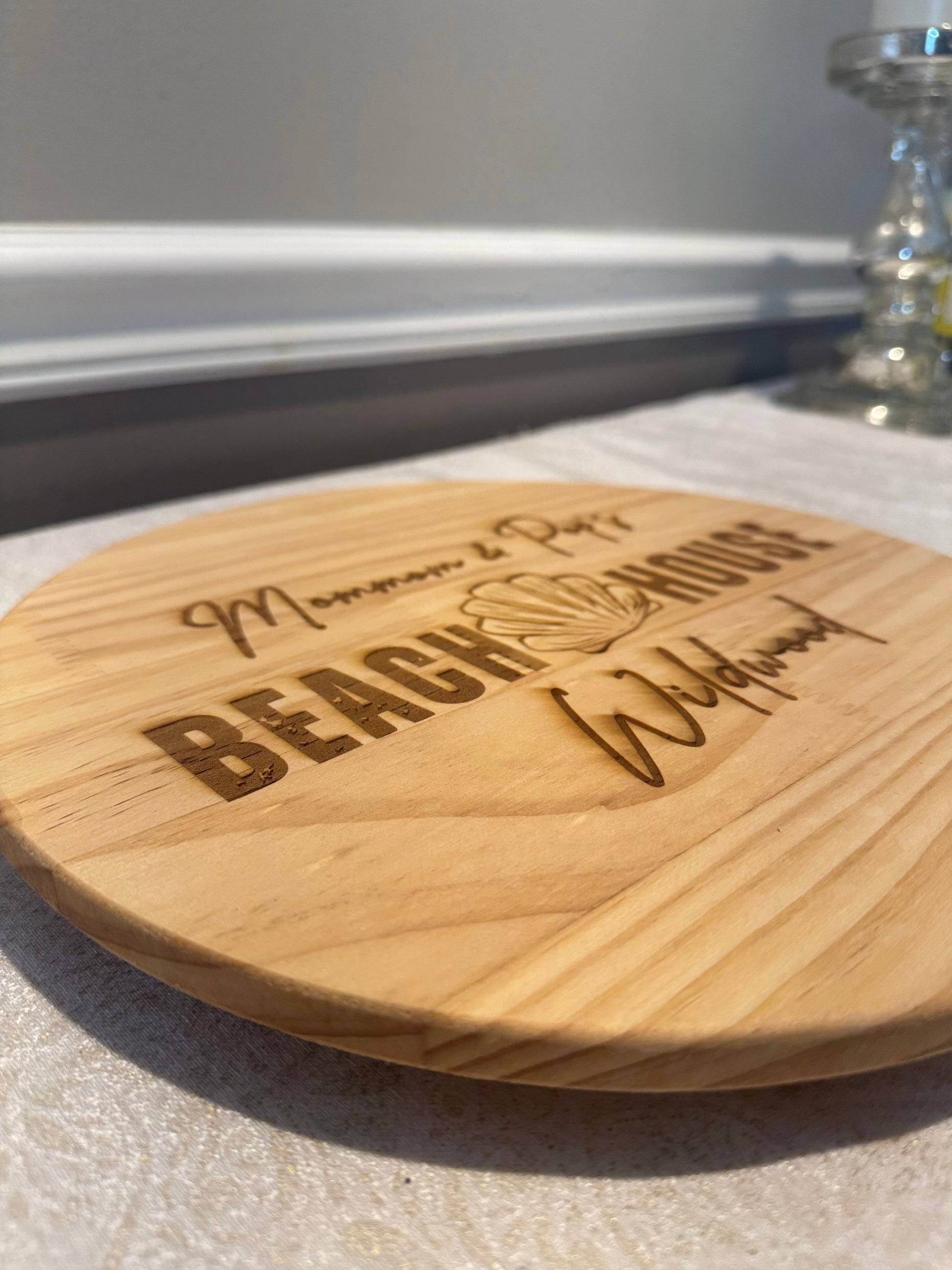 Wooden coaster with engraved text on a light surface