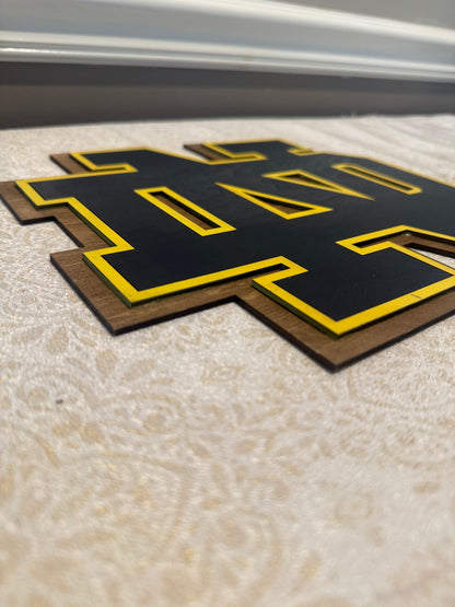 Black and yellow logo on a textured surface