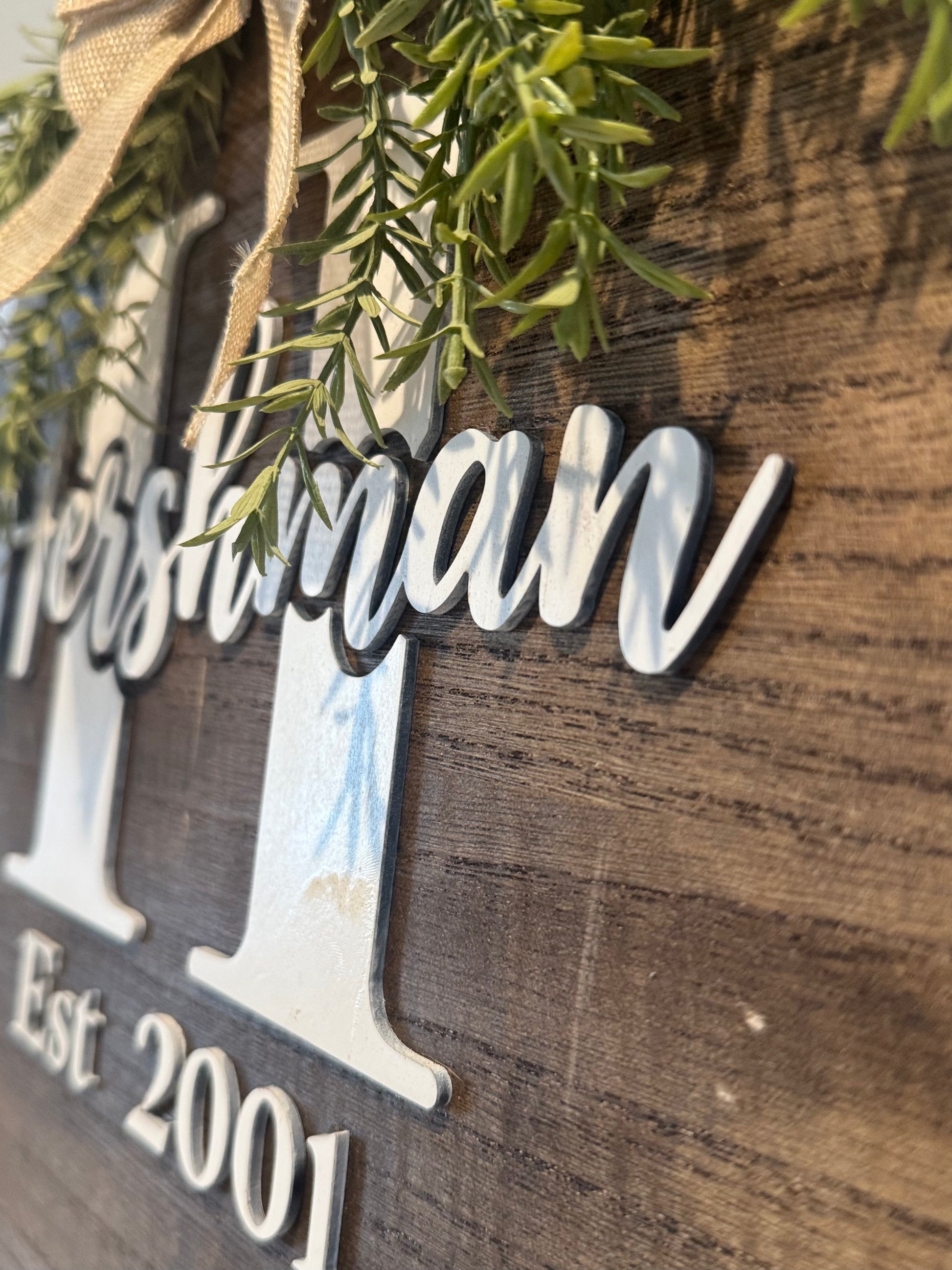 Wooden sign with 'Fathersman' and 'Est. 2001' on a rustic background